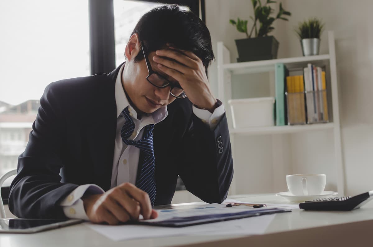 frustrated marketing manager with marketing plan rejected by manufacturing exectutives