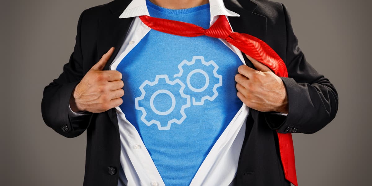Business man opening shirt like a superhero to reveal blue shirt with gear icon